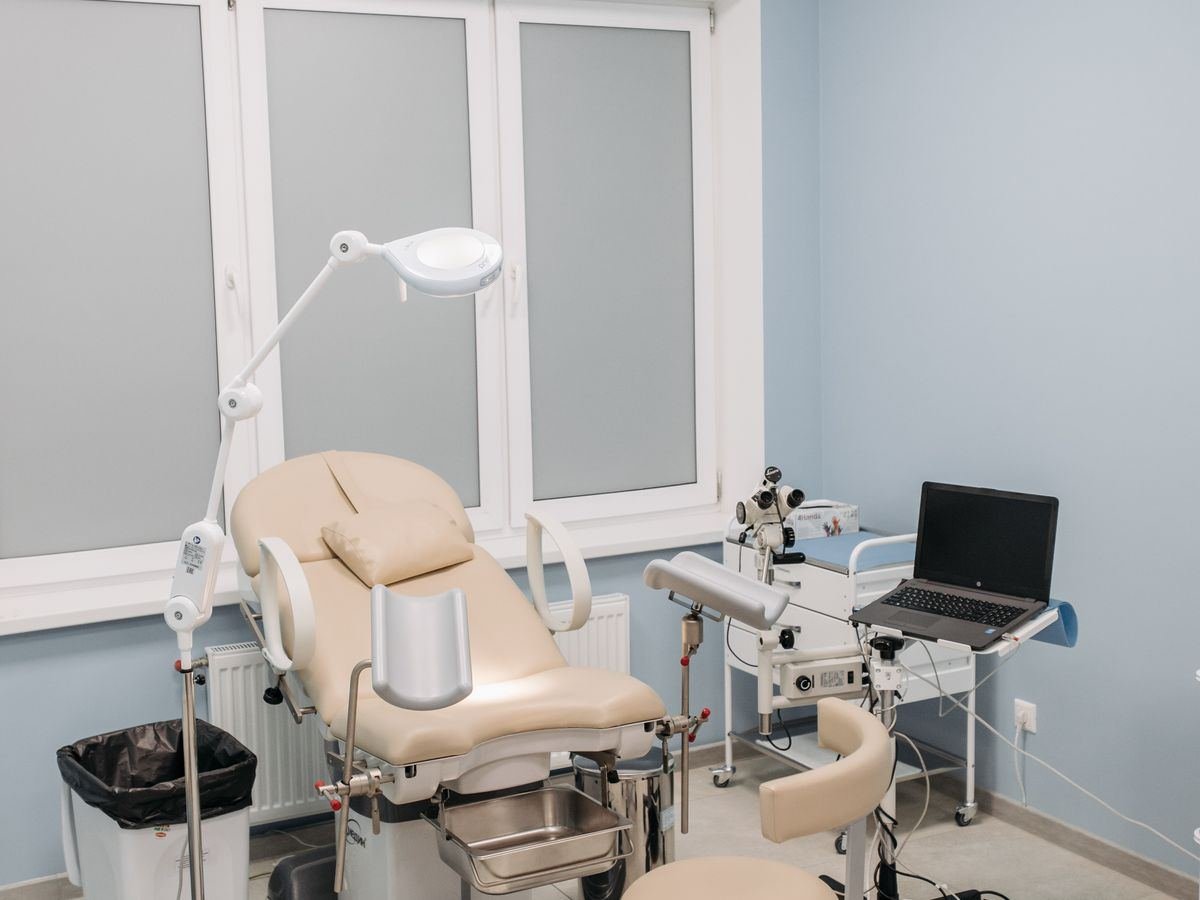 A clean and modern eye clinic examination room prepared for a patient consultation