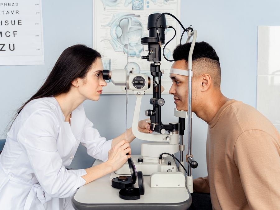 An eye care professional examining a patient during a vision test